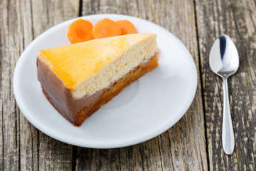 Sweet slice of carrot cake on white plate.