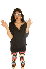 Unsure woman wearing colorful leggings her hands up undecided ex