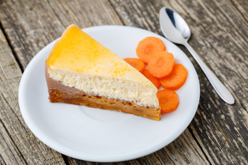 Sweet slice of carrot cake on white plate.