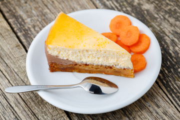 Sweet slice of carrot cake on white plate.