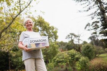 Happy grandmother holding donation box