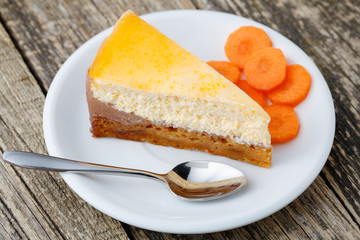 Sweet slice of carrot cake on white plate.