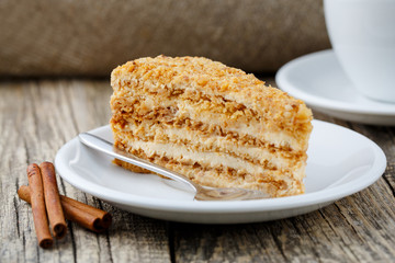 Tasty honey cake on wooden background.