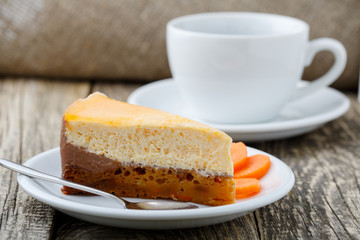 Sweet slice of carrot cake with coffee cup.