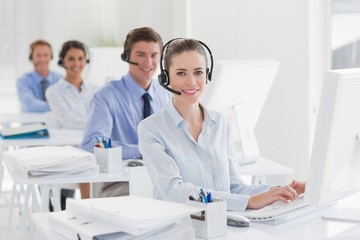 Fototapeta premium Business team working on computers and wearing headsets