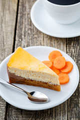 Sweet slice of carrot cake with coffee cup.