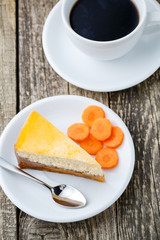 Sweet slice of carrot cake with coffee cup.