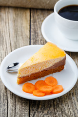 Sweet slice of carrot cake with coffee cup.