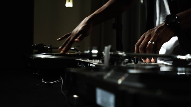 Dj spins records at house party.