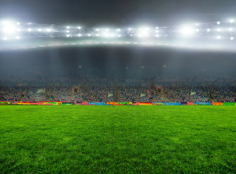 Soccer stadium, arena in night illuminated bright spotlights