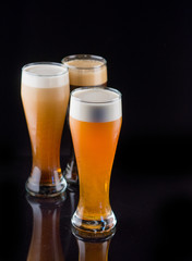 Three glasses of beer with high foam