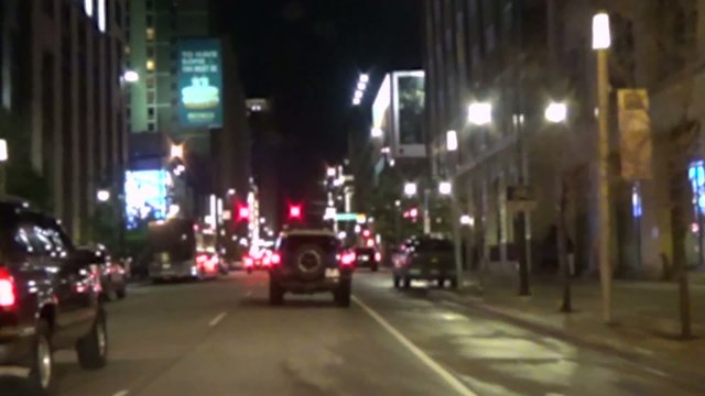 Time lapse of a bright city street at night
