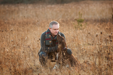man in a field with his springer spaniel dog