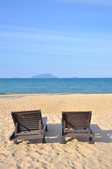 Fototapeta na wymiar Beach chairs on sand beach. 