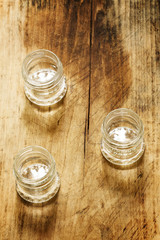 Empty small glass jar on a wooden table, selective focus