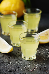 Italian traditional liqueur limoncello with lemon