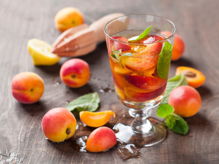 Summer drink with apricot ( or peach)  in glass, selective focus
