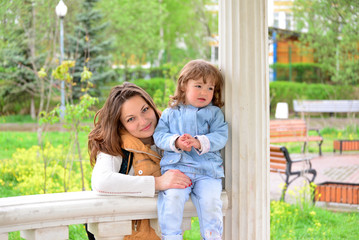 Fototapeta premium Mom and daughter 2.5 years for a walk in gazebo