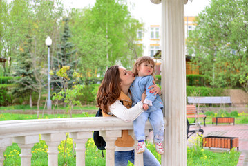 Fototapeta premium Mom and daughter 2.5 years for a walk in gazebo