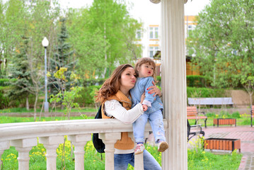 Fototapeta premium Mom and daughter 2.5 years for a walk in gazebo