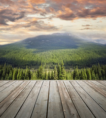 Wooden deck overlooking scenic view of mountains
