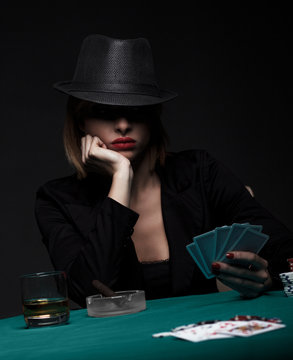Beautiful young woman playing poker