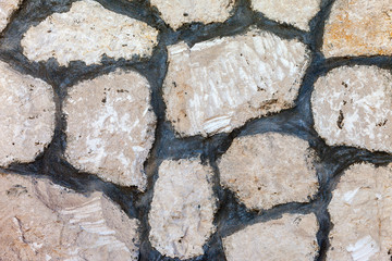 Fragment of a grey stone wall as background