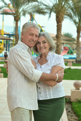 Senior couple at tropic hotel garden