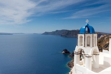 Fototapeta na wymiar Blue and white church of Oia village on Santorini island. Greece
