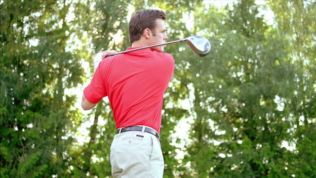 A Man Steps Up To His Ball And Then Takes A Perfect Swing At It