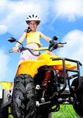 Child girl rides on quad