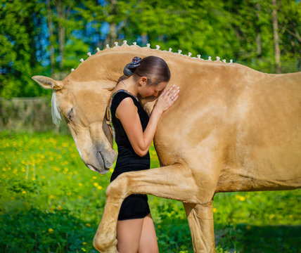 Girl hugging horse