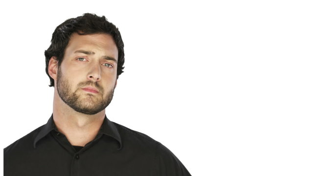 Man with a beard looks sad into the camera on a white background