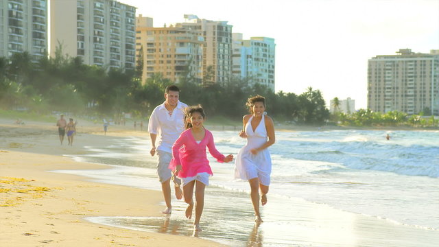 A family runs down the beach together