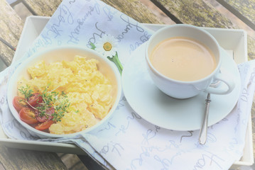 Aerial view tasty scrambled eggs on plate wooden background
