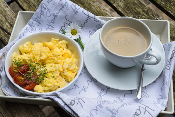 Aerial view fresh scrambled eggs on plate wooden background