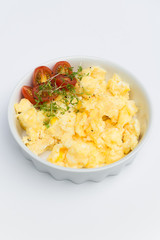 Aerial view tasty fresh scrambled eggs on plate white background