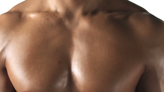 Close up shot of an ethnic athlete with no shirt on and big muscles