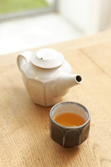 kettle and tea cup on table
