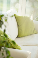 White sofa and mustard pillows