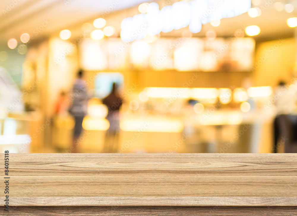Poster Empty wood table top with coffee shop blur with bokeh background