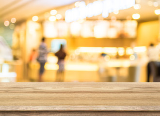 Fototapeta na wymiar Empty wood table top with coffee shop blur with bokeh background