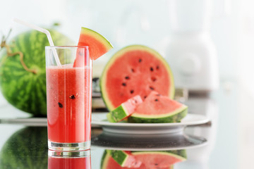 Glass of fresh watermelon juice on kitchen table