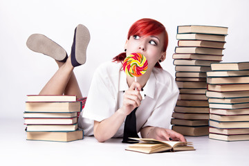 The girl in anime style with candy and books