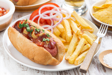 fast food - hot dog with French fries and chips, close-up