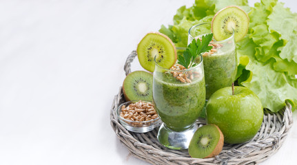 healthy green smoothie with sprouts on a white wooden table