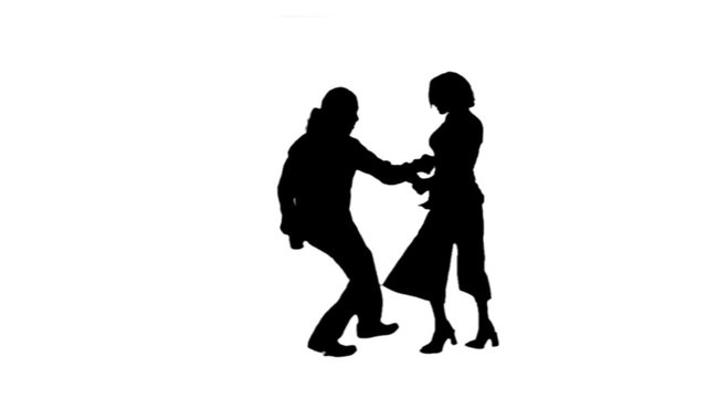 A salsa dancing couple silhouetted on blue dance energetically