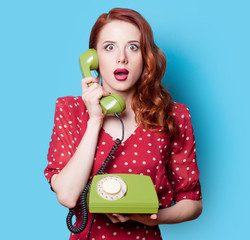 girl in red dress with green dial phone