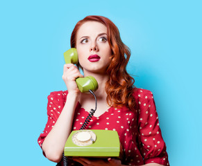 girl in red dress with green dial phone