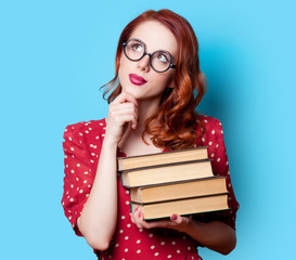 girl in red dress with books